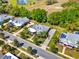 Aerial shot showcasing landscaped lawns, paved driveways and mature trees surrounding lovely homes at 1172 Fiesta Key Cir, Lady Lake, FL 32159
