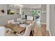 View of the dining room with a wood table, upholstered chairs, and open floor plan at 1172 Fiesta Key Cir, Lady Lake, FL 32159