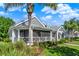 Charming home exterior with a screened porch, lush landscaping, and a well-manicured lawn at 1172 Fiesta Key Cir, Lady Lake, FL 32159