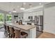 Bright kitchen featuring stainless steel appliances, a center island with seating, and ample counter space at 1172 Fiesta Key Cir, Lady Lake, FL 32159