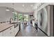 Modern kitchen featuring stainless steel appliances, a breakfast bar, and a adjacent dining area at 1172 Fiesta Key Cir, Lady Lake, FL 32159