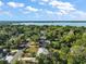 Stunning aerial view showcasing the neighborhood, a nearby lake, lush trees, and a clear view of the beautiful landscape at 1313 Crestview Dr, Mount Dora, FL 32757