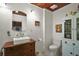 Charming bathroom features an antique cabinet, sink and medicine cabinet with exposed-beam ceiling at 1313 Crestview Dr, Mount Dora, FL 32757