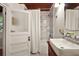 Bathroom features a shower over the tub, frosted glass door and marble tile surround at 1313 Crestview Dr, Mount Dora, FL 32757