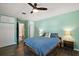 Cozy bedroom features a ceiling fan and a calming light-green painted accent wall at 1313 Crestview Dr, Mount Dora, FL 32757