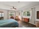 Bright bedroom with wood floors and plenty of natural light from large windows at 1313 Crestview Dr, Mount Dora, FL 32757