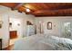 Bedroom features a sloped-beam ceiling and an en-suite bathroom at 1313 Crestview Dr, Mount Dora, FL 32757