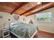 Bedroom features a sloped beam ceiling, hardwood floors and a large sunlit window at 1313 Crestview Dr, Mount Dora, FL 32757