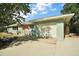 Charming home featuring an attached garage, beautiful landscaping and a red door at 1313 Crestview Dr, Mount Dora, FL 32757