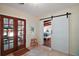 Foyer with tile floor, Dutch doors and barn-style slider door leading to the bedroom at 1313 Crestview Dr, Mount Dora, FL 32757