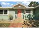 Inviting front entrance featuring a bright front door, stone steps, and a well-maintained facade at 1313 Crestview Dr, Mount Dora, FL 32757