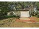 Detached garage with brick paver parking area, and mature landscaping at 1313 Crestview Dr, Mount Dora, FL 32757