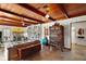 Open living room showcasing the exposed wood ceiling, built-in bookshelves, and an adjacent doorway at 1313 Crestview Dr, Mount Dora, FL 32757