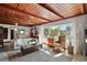 Bright living room with a wood ceiling, large windows, and comfortable furnishings at 1313 Crestview Dr, Mount Dora, FL 32757
