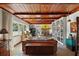 Spacious living room featuring a wood ceiling, ample natural light, built-in bookshelves, and a fireplace at 1313 Crestview Dr, Mount Dora, FL 32757