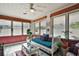 Bright sunroom with white ceiling, daybed and decorative pillows, and many windows at 1313 Crestview Dr, Mount Dora, FL 32757
