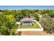 Aerial view of the home and backyard featuring a screened pool and fenced yard at 13319 Via Roma Cir, Clermont, FL 34711