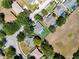 Aerial view of neighborhood featuring mature trees and in-ground pools at 13319 Via Roma Cir, Clermont, FL 34711