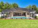 Expansive backyard with a pool, screened enclosure, and well-maintained landscaping for outdoor enjoyment at 13319 Via Roma Cir, Clermont, FL 34711