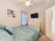 Comfortable bedroom with a ceiling fan and a mounted flat screen television at 13319 Via Roma Cir, Clermont, FL 34711