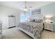 Bright bedroom with ceiling fan, tile floors, and an elegant white dresser and nightstands at 13319 Via Roma Cir, Clermont, FL 34711