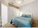 Bright bedroom featuring a comfortable bed with soft, blue bedding and a ceiling fan at 13319 Via Roma Cir, Clermont, FL 34711