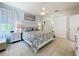 Comfortable bedroom with ceiling fan and ensuite bathroom featuring tile floors at 13319 Via Roma Cir, Clermont, FL 34711