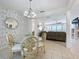 Traditional dining room with glass table and sightlines to the living room at 13319 Via Roma Cir, Clermont, FL 34711