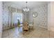 Traditional dining room with patterned wall coverings, chandelier and large window at 13319 Via Roma Cir, Clermont, FL 34711
