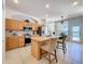 Well-lit kitchen featuring stainless steel appliances, tile flooring, and a functional center island with seating at 13319 Via Roma Cir, Clermont, FL 34711
