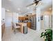 Well-lit kitchen featuring stainless steel appliances, tile flooring, and a functional center island with seating at 13319 Via Roma Cir, Clermont, FL 34711