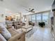 Spacious living room is perfect for relaxing, featuring large windows and access to the screened-in pool area at 13319 Via Roma Cir, Clermont, FL 34711