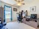 Well-lit home office with a large window, desk, and ample storage space for productivity at 13319 Via Roma Cir, Clermont, FL 34711