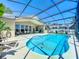 Beautiful backyard featuring a sparkling pool, screened enclosure, and an inviting outdoor space at 13319 Via Roma Cir, Clermont, FL 34711