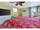 Bright bedroom featuring a ceiling fan, dresser, and a comfortable bed with patterned bedding at 1401 W Highway 50 # 142, Clermont, FL 34711