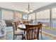 Inviting dining area with a wooden table, views of the waterfront and a glimpse of the outdoor patio at 1401 W Highway 50 # 142, Clermont, FL 34711