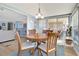 Cozy dining area with a wooden table, seating for four, and sliding glass doors to the outdoor patio at 1401 W Highway 50 # 142, Clermont, FL 34711