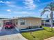Charming single-story home with a well-manicured lawn, mature landscaping, and a driveway with car at 1401 W Highway 50 # 142, Clermont, FL 34711