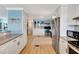 Bright kitchen featuring white cabinetry and modern appliances with a view to a study room at 1401 W Highway 50 # 142, Clermont, FL 34711