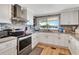 Modern kitchen with stainless steel appliances, white cabinets, and a window overlooking the water at 1401 W Highway 50 # 142, Clermont, FL 34711