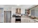 Modern kitchen with stainless steel appliances, white cabinets, and a stylish backsplash at 1401 W Highway 50 # 142, Clermont, FL 34711