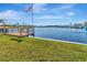 Lakefront property boasting a private dock with an American flag at 1401 W Highway 50 # 142, Clermont, FL 34711