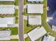 An aerial view showcasing the community homes, a blacktop road, and waterway access at 1401 W Highway 50 # 143, Clermont, FL 34711