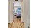Light and airy bedroom features wood floors, bedside table with lamp and blue and white quilt at 1401 W Highway 50 # 143, Clermont, FL 34711