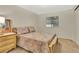 Cozy bedroom featuring a colorful comforter, a window and a wooden night stand at 1401 W Highway 50 # 143, Clermont, FL 34711