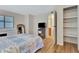 This light and airy bedroom has light wood flooring and a walk-in closet at 1401 W Highway 50 # 143, Clermont, FL 34711