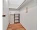 Walk in closet with multiple shelves and wood floor at 1401 W Highway 50 # 143, Clermont, FL 34711