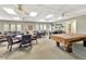Clubhouse interior with ample seating, tables, and a billiards table in a relaxed setting at 1401 W Highway 50 # 143, Clermont, FL 34711