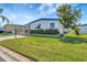 Well-maintained single-story home with lush green lawn and vibrant landscaping at 1401 W Highway 50 # 143, Clermont, FL 34711