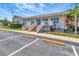 Exterior showcases a light-colored home with a white railing, and manicured landscaping at 1401 W Highway 50 # 143, Clermont, FL 34711